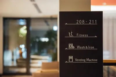 a sign that says fitness west and lion on a wall at NOHGA HOTEL UENO TOKYO in Tokyo