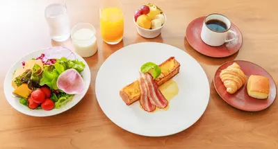 a table with two plates of breakfast foods and drinks at NOHGA HOTEL UENO TOKYO in Tokyo