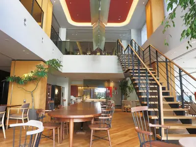 a staircase in a restaurant with a table and chairs at NOHGA HOTEL UENO TOKYO in Tokyo