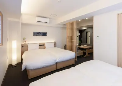 a hotel room with two beds and a desk at MIMARU Tokyo Ueno East in Tokyo