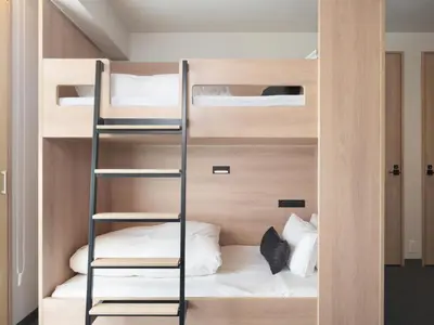 a room with bunk beds and a ladder at MIMARU Tokyo Ueno East in Tokyo