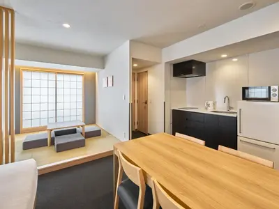 a kitchen and dining room with a wooden table at MIMARU Tokyo Ueno Inaricho in Tokyo