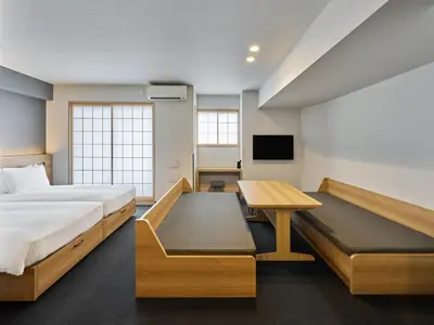 a bedroom with a bed and a desk and a tv at MIMARU Tokyo Ueno Inaricho in Tokyo