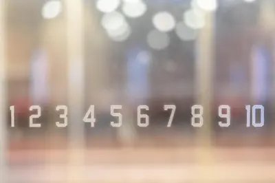 a close up of a clock with numbers on it at Belken Hotel Kanda in Tokyo