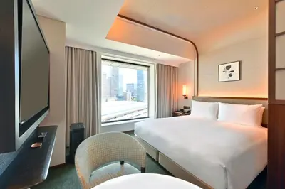 a hotel room with a bed and a window at Marunouchi Hotel in Tokyo