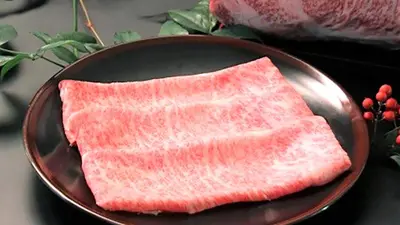 a plate with two pieces of meat on it at Ueno Terminal Hotel in Tokyo