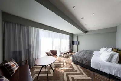 a hotel room with a bed and a table at SHIBUYA STREAM HOTEL formerly Shibuya Stream Excel Hotel Tokyu in Tokyo