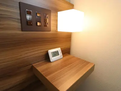 a clock sitting on a table in a room at Tokyo Inn in Tokyo