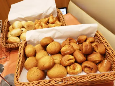two baskets filled with different types of donuts on a table at Tokyo Inn in Tokyo