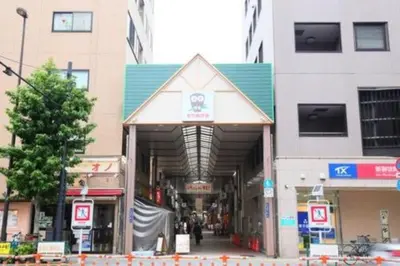 a building on a city street with people walking through it at ICI HOTEL Ueno Shin Okachimachi in Tokyo