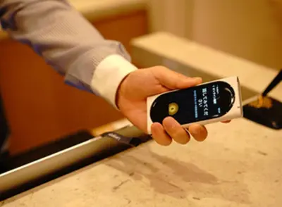 a person holding a cell phone in their hand at ICI HOTEL Ueno Shin Okachimachi in Tokyo
