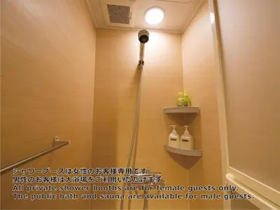 a shower with a shower head in a bathroom at Shinjuku Kuyakusho-mae Capsule Hotel in Tokyo