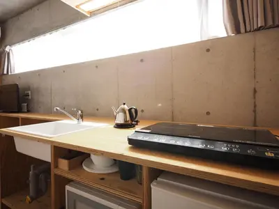 a kitchen with a sink and a counter top at Smi:re Stay Oshiage in Tokyo