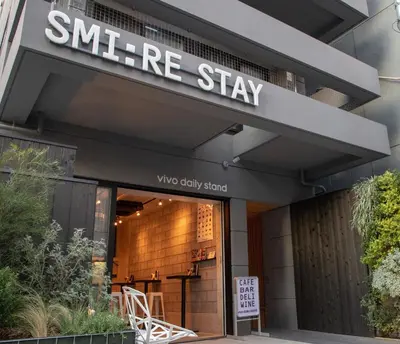 a store front with a sign that readsnance stay at Smi:re Stay Oshiage in Tokyo