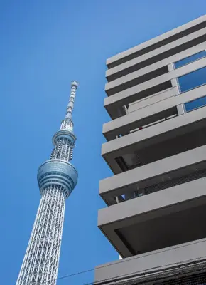 a view of the eiffel tower from between two buildings at Smi:re Stay Oshiage in Tokyo