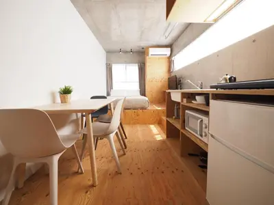 a small kitchen and dining room with a table and chairs at Smi:re Stay Oshiage in Tokyo
