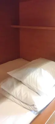 a bed with two white pillows on it at Ace Inn Shinjuku in Tokyo