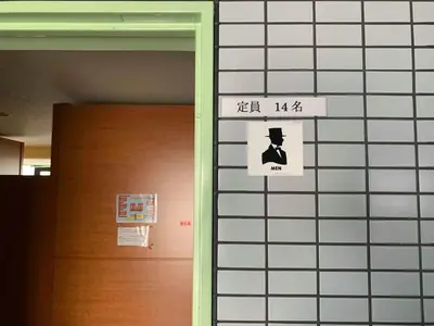 a sign on a wall next to a door at Ace Inn Shinjuku in Tokyo
