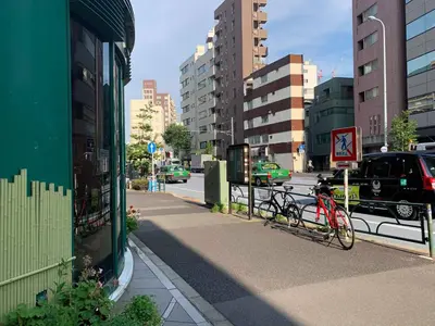 two bikes parked on a sidewalk in a city at Ace Inn Shinjuku in Tokyo