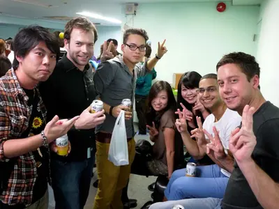 a group of people posing for a picture in a crowd at Ace Inn Shinjuku in Tokyo