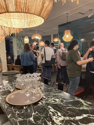 a group of people standing around a table with wine glasses at Ace Inn Shinjuku in Tokyo