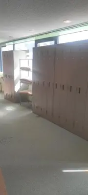 a locker room with white lockers in a building at Ace Inn Shinjuku in Tokyo