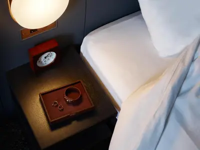 a bedroom with a bed and a clock on a table at Mitsui Garden Hotel Shiodome Italia-gai - Tokyo in Tokyo