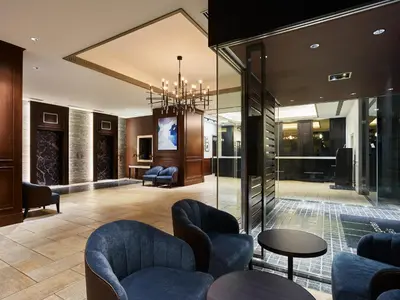 a lobby with chairs and tables in a building at Mitsui Garden Hotel Shiodome Italia-gai - Tokyo in Tokyo