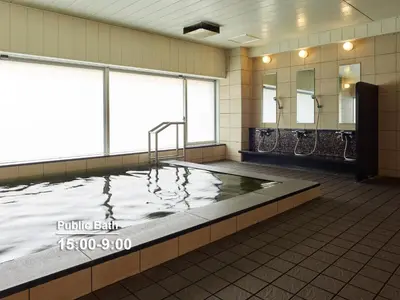 a large pool of water in a bathroom with mirrors at Mitsui Garden Hotel Shiodome Italia-gai - Tokyo in Tokyo