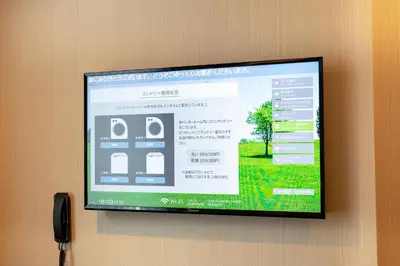 a flat screen tv hanging on a wall at Ginza Capital Hotel Moegi in Tokyo