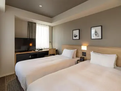 a hotel room with two beds and a television at Best Western Hotel Fino Tokyo Akihabara in Tokyo