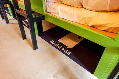 a green bunk bed with a drawer under it at plat hostel keikyu asakusa station in Tokyo