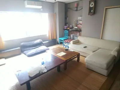 a living room with a couch and a coffee table at GUEST HOUSE SaKURa in Tokyo