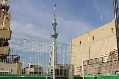 a view of the berlin tv tower through a fence at GUEST HOUSE SaKURa in Tokyo