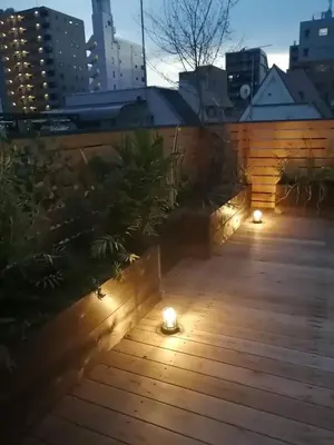 a patio with lights on a wooden deck at GUEST HOUSE SaKURa in Tokyo