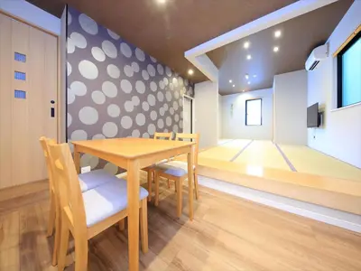a dining room with a table and chairs and a dance floor at COTO Tokyo Asakusa 5 in Tokyo