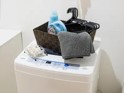 a basket on top of a toilet with a bottle on it at COTO Tokyo Asakusa 5 in Tokyo