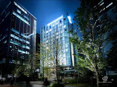 a tall building with people walking in front of it at Daiwa Roynet Hotel Nishi-Shinjuku PREMIER in Tokyo