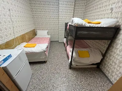 a small room with two bunk beds in it at Shinjuku Sky hostel in Tokyo