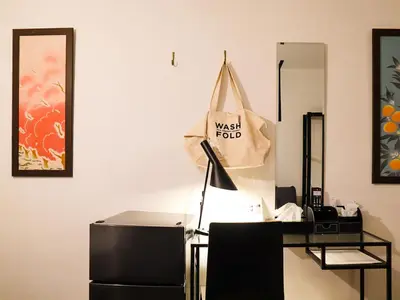 a room with a desk with a wast job bag on the wall at waves nakameguro in Tokyo