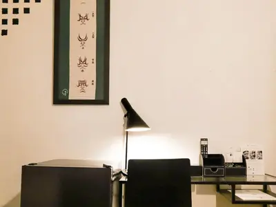an office with a desk and a lamp on a wall at waves nakameguro in Tokyo
