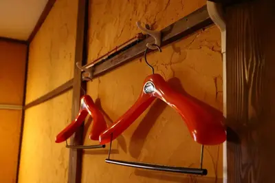 two red umbrellas are hanging on a wall at Kingyosou in Tokyo