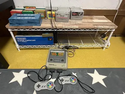 a table with two video game controllers on a shelf at Kingyosou in Tokyo