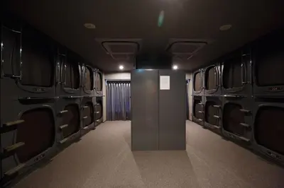 a dark room with a door in the middle at The Nell Ueno Okachimachi in Tokyo