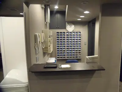 a hospital room with a reception desk and a clock at The Nell Ueno Okachimachi in Tokyo