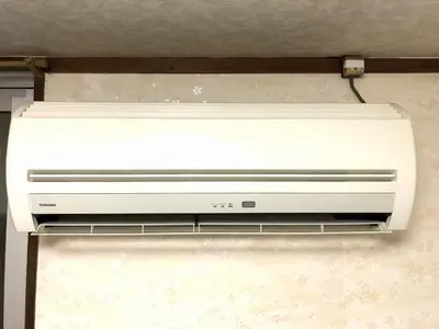 a white printer is hanging from a ceiling at Asakusa Ryokan Toukaisou in Tokyo