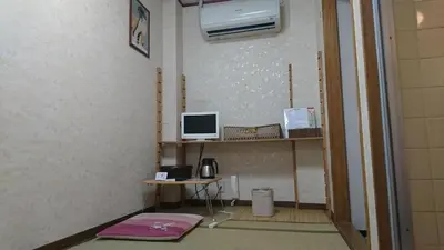 a room with a desk with a computer on a wall at Asakusa Ryokan Toukaisou in Tokyo