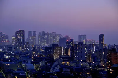 a city skyline at night with many tall buildings at Tokyo Central Youth Hostel in Tokyo
