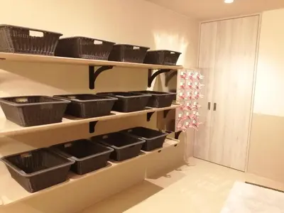 a kitchen with baskets on shelves in a room at Tokyo Central Youth Hostel in Tokyo
