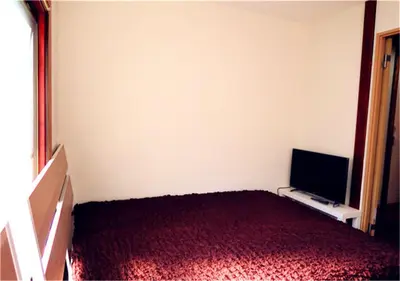 a bedroom with a bed and a flat screen tv at Kiki HouseT --Self Check-in -- Room Number & Password is in the following email in Tokyo